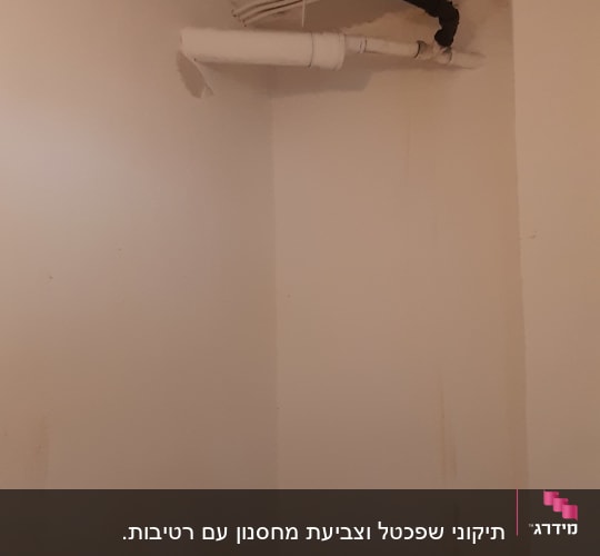 סולם צבוע בצבע לבן ליד קיר עם צינורות